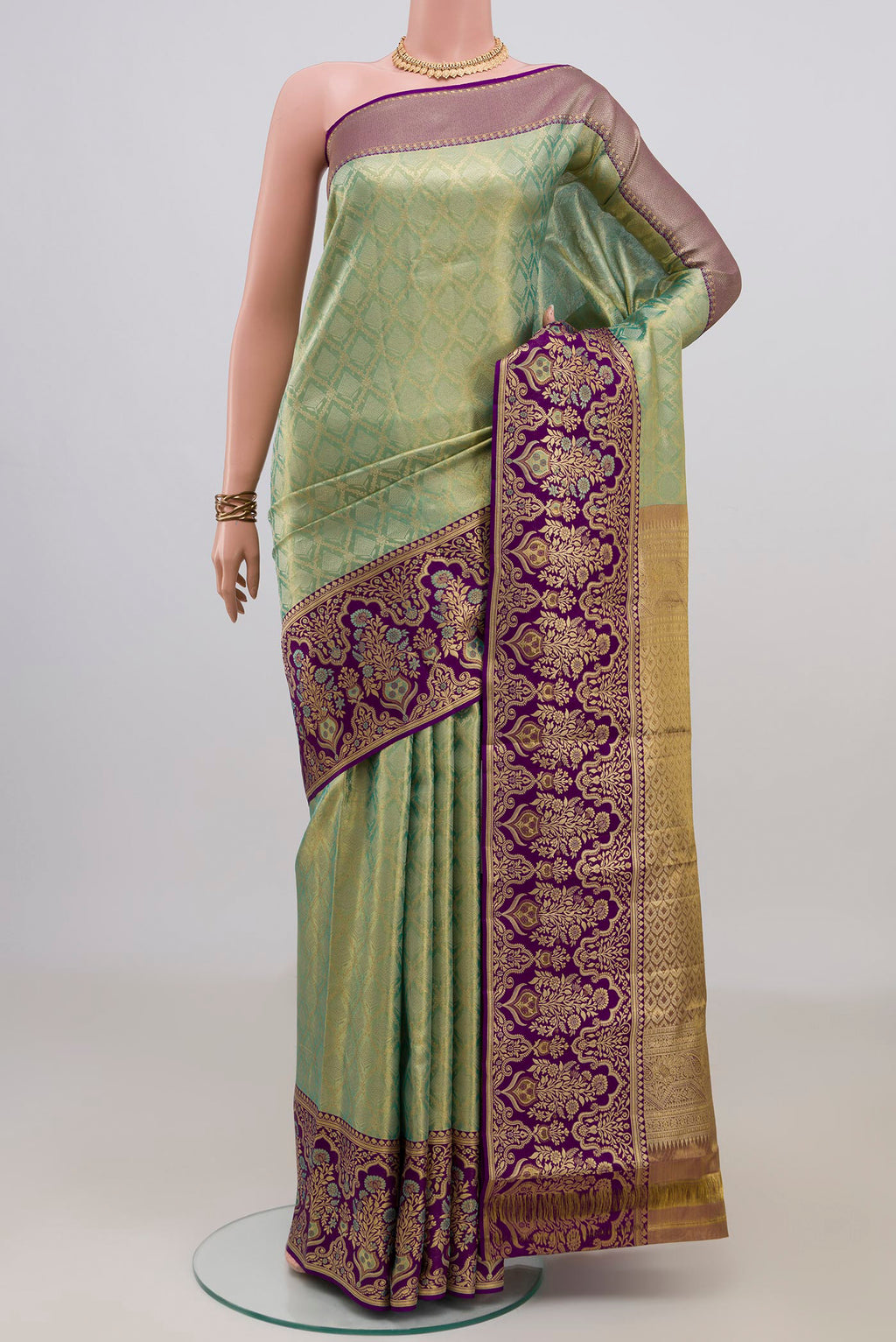 Green Dual Tone Kanjivaram Saree with Zari Brocade on the body and Fancy Border.  displayed on a mannequin