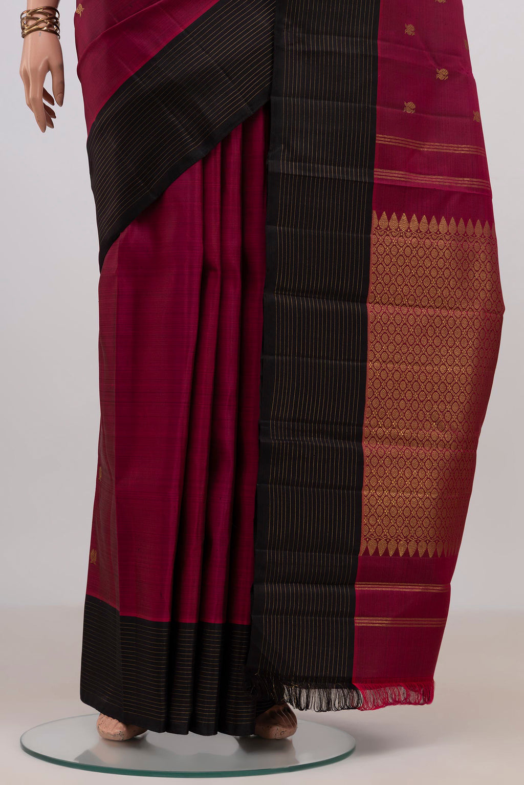 Pleats and pallu of Pure Silk Pure Zari Maroon Kanchipuram Saree with Zari Butta on the body and Plain Border. 