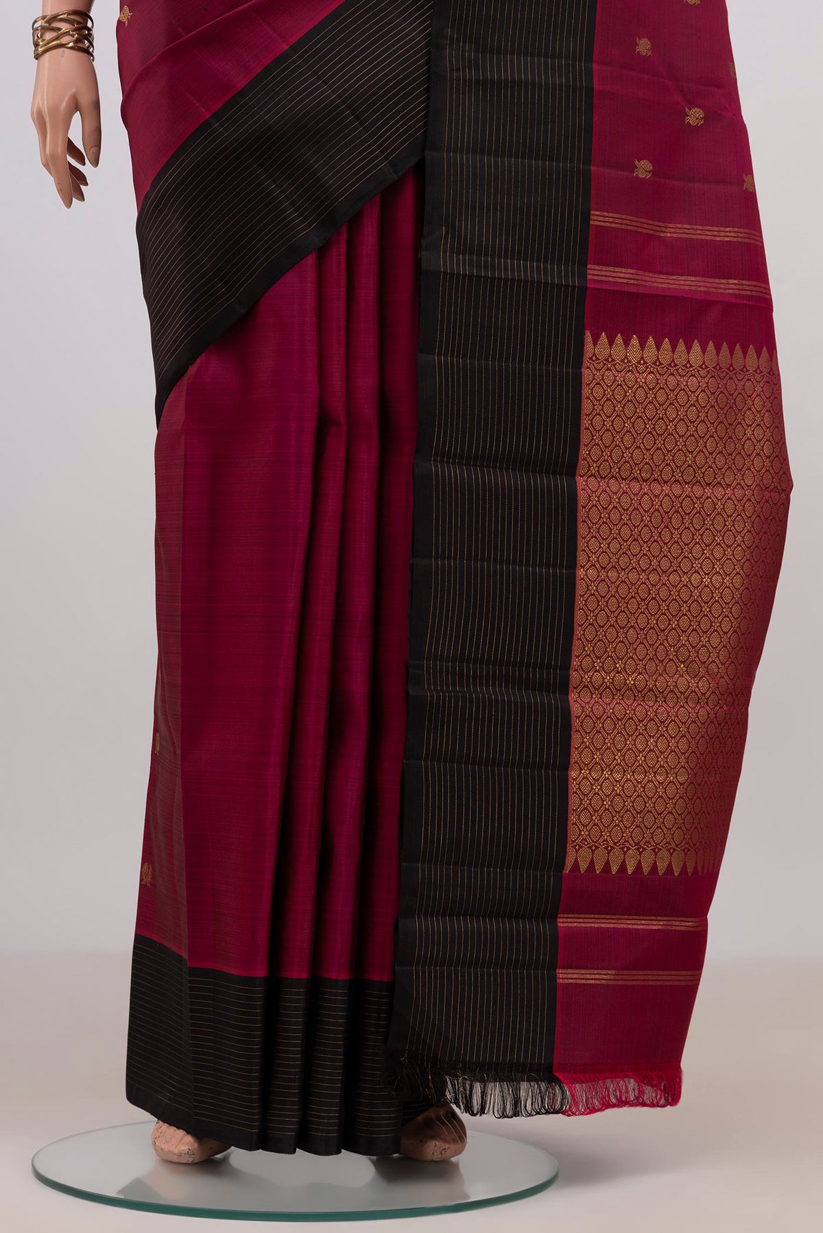 Pleats and pallu of Pure Silk Pure Zari Maroon Kanchipuram Saree with Zari Butta on the body and Plain Border. 