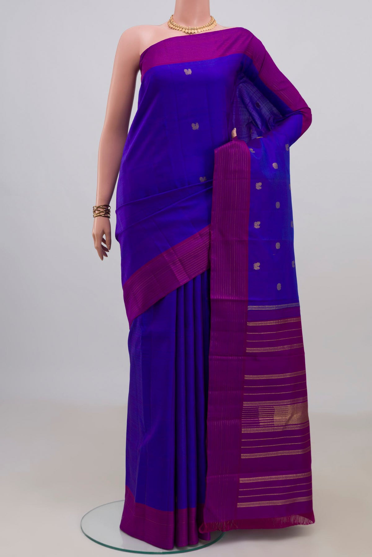 Pure Silk Pure Zari Royal Blue Kanjivaram Saree with Zari Butta on the body and Plain Border.  displayed on a mannequin