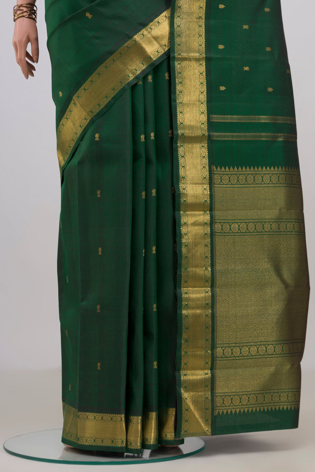 Pleats and pallu of Pure Silk Pure Zari Bottle Green Kanjivaram Saree with Zari Butta on the body and Zari Border. 