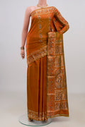 Pure Silk Rust Baluchari Saree with Zari And Thread Butta on the body and Fancy Border.  displayed on a mannequin