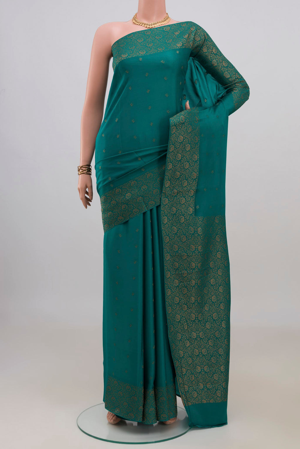 Teal Mysore Crepe Saree with Zari Butta on the body and Fancy Border.  displayed on a mannequin