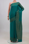 Teal Mysore Crepe Saree with Zari Butta on the body and Fancy Border.  displayed on a mannequin