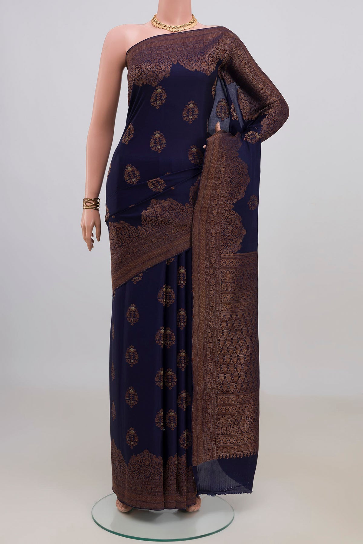Navy Blue Crepe Saree with Zari Butta on the body and Fancy Border.  displayed on a mannequin