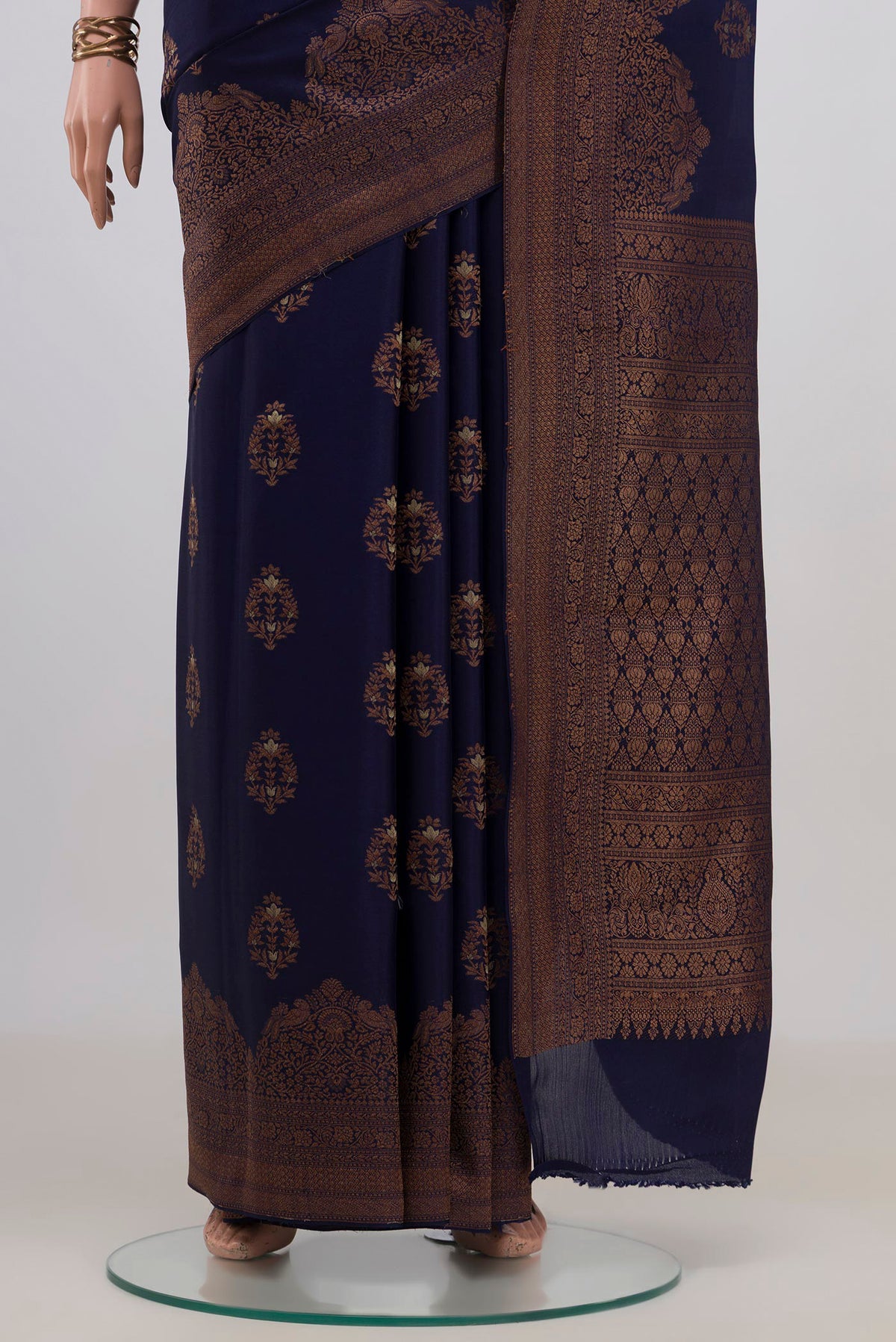 Pleats and pallu of Navy Blue Crepe Saree with Zari Butta on the body and Fancy Border. 