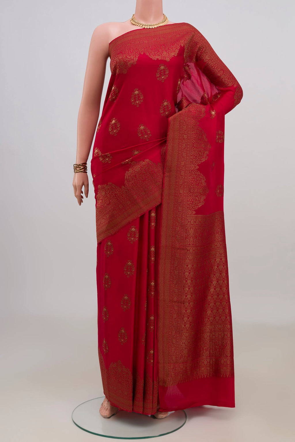 Red Mysore Crepe Saree with Zari Butta on the body and Fancy Border.  displayed on a mannequin