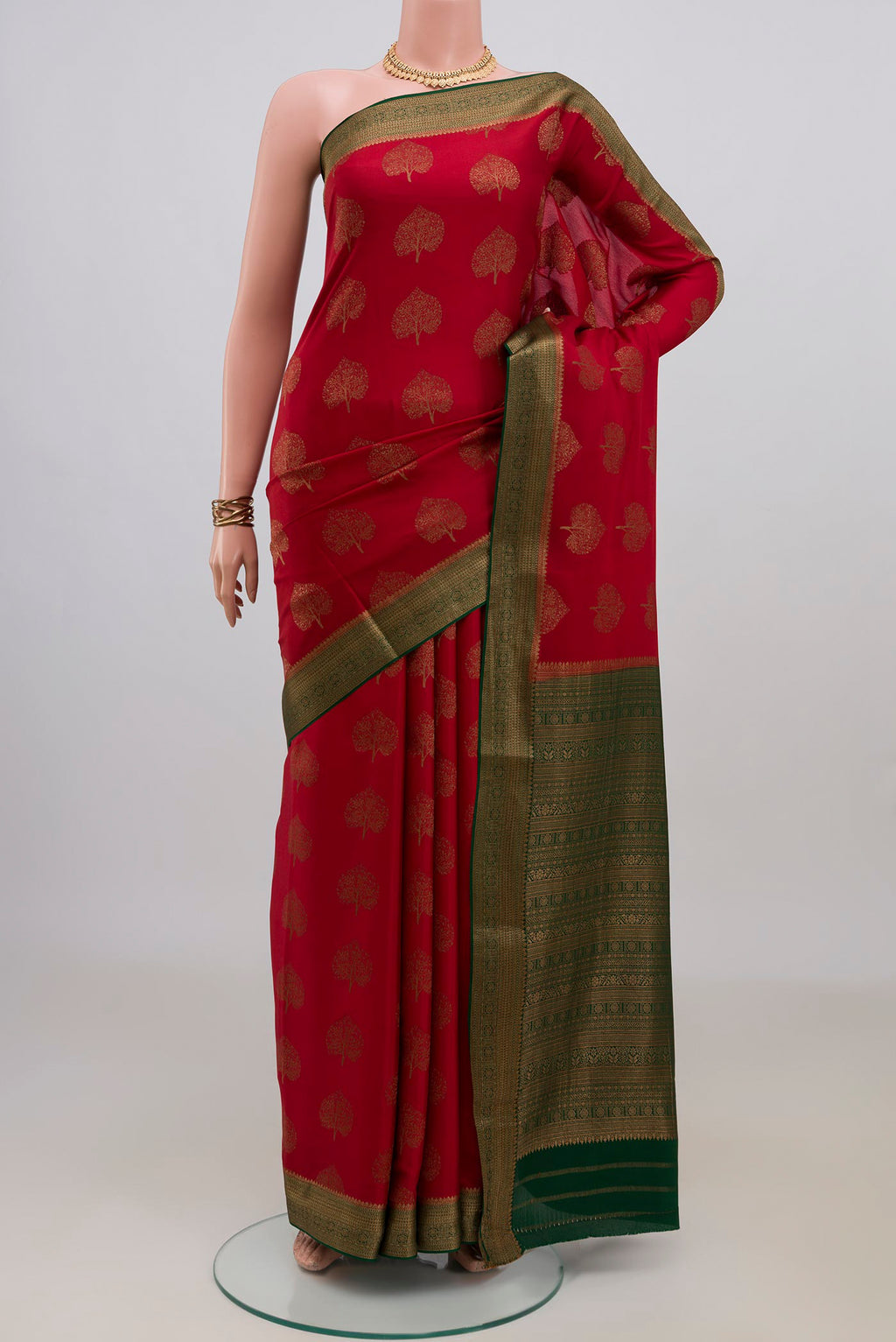 Red Mysore Crepe Saree with Zari Butta on the body and Zari Border.  displayed on a mannequin