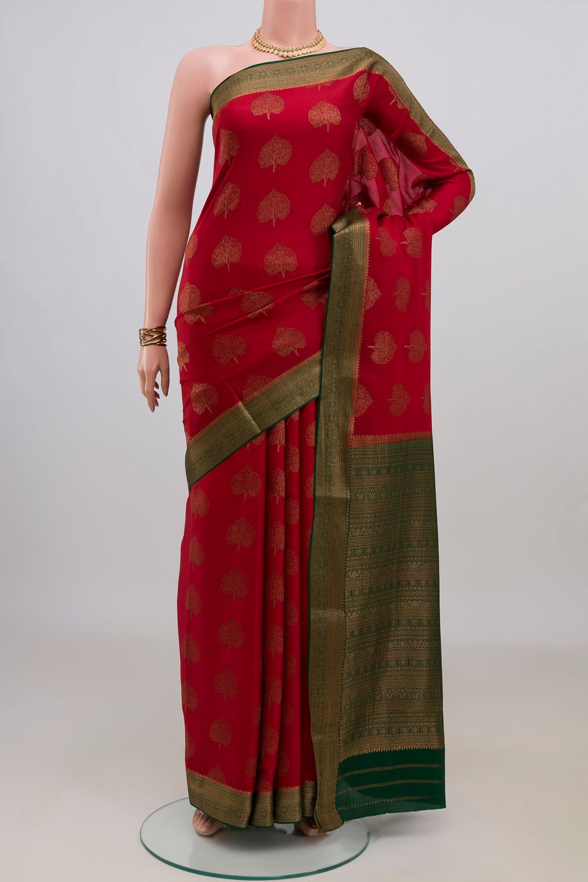 Red Mysore Crepe Saree with Zari Butta on the body and Zari Border.  displayed on a mannequin