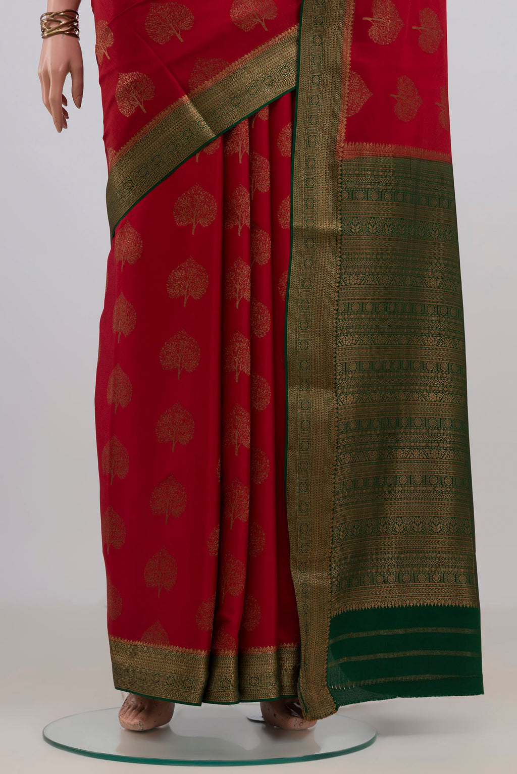 Pleats and pallu of Red Mysore Crepe Saree with Zari Butta on the body and Zari Border. 