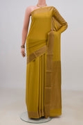 Mustard Crepe Saree with Plain Body and Zari Border.  displayed on a mannequin