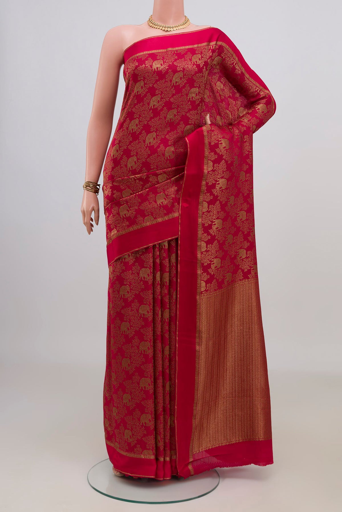 Red Crepe Saree with Fancy on the body and Thin Zari Line.  displayed on a mannequin