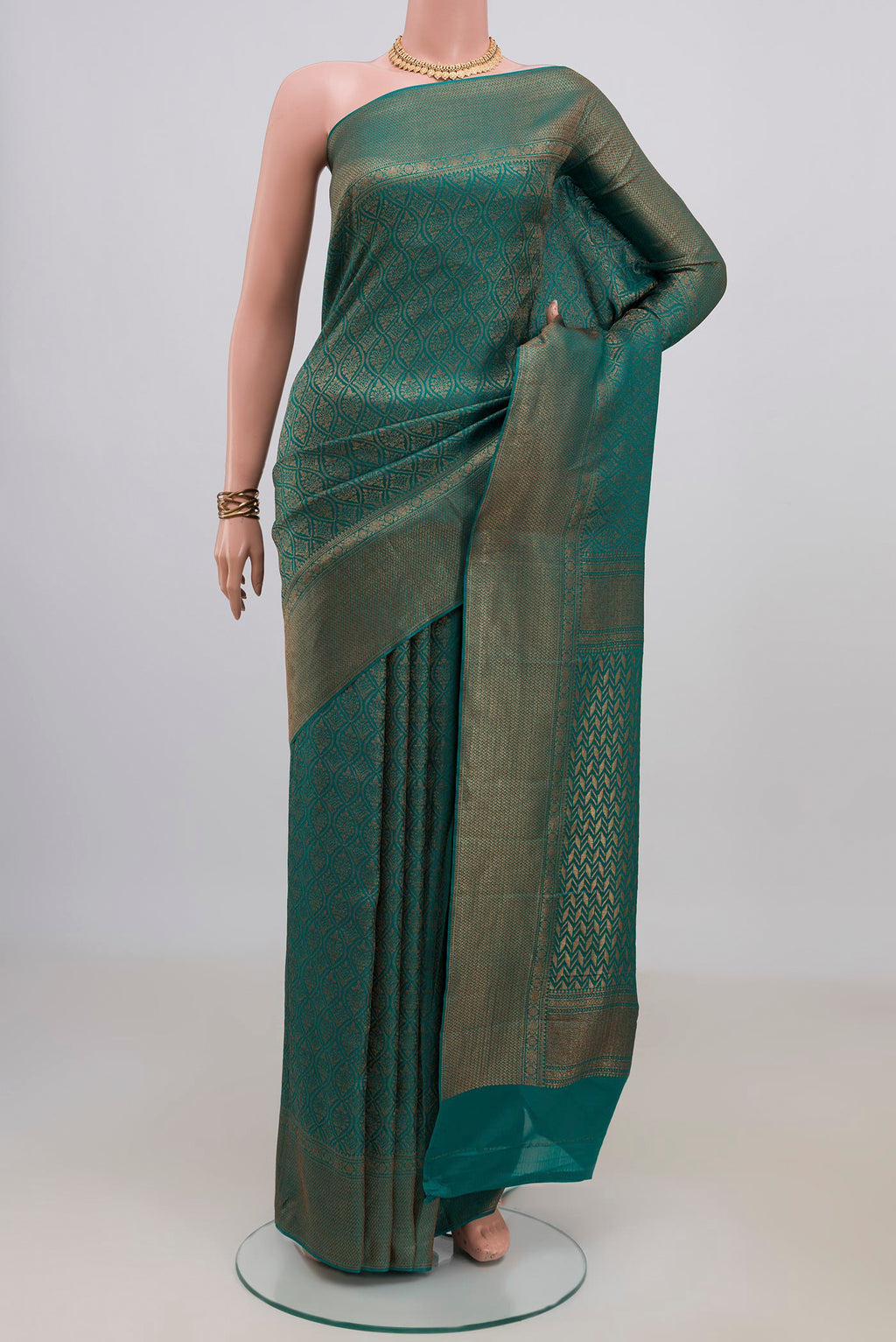 Teal Crepe Saree with Zari Brocade on the body and Fancy Border.  displayed on a mannequin