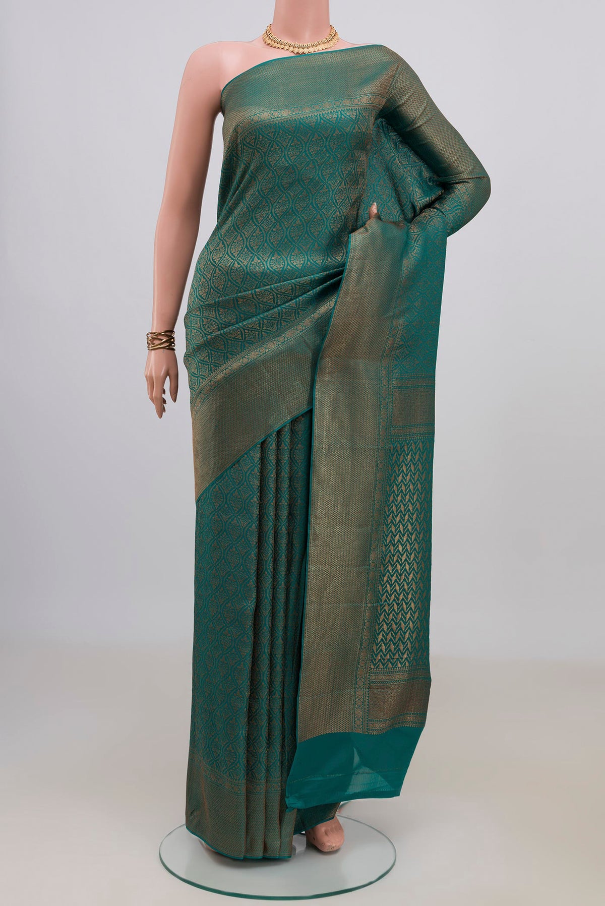 Teal Crepe Saree with Zari Brocade on the body and Fancy Border.  displayed on a mannequin