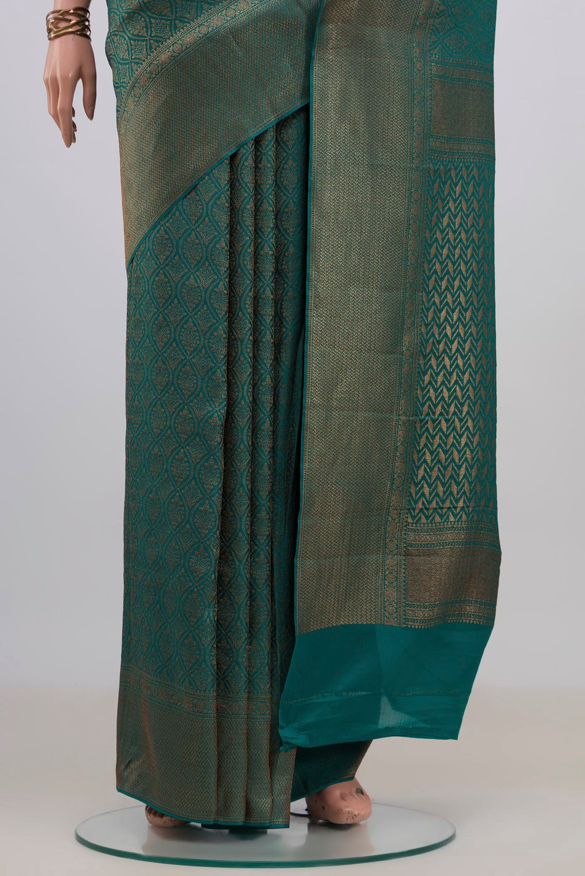 Pleats and pallu of Teal Crepe Saree with Zari Brocade on the body and Fancy Border. 
