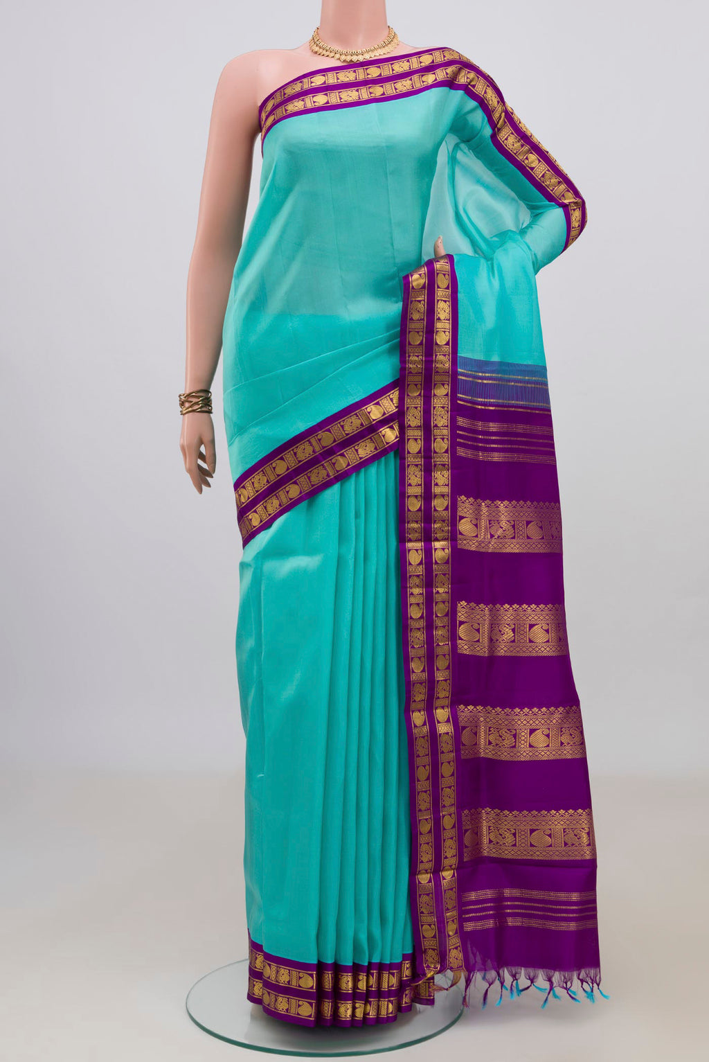 Pure Silk Turquoise Kanjivaram Nine Yards Saree with Plain Body and Zari Border.  displayed on a mannequin