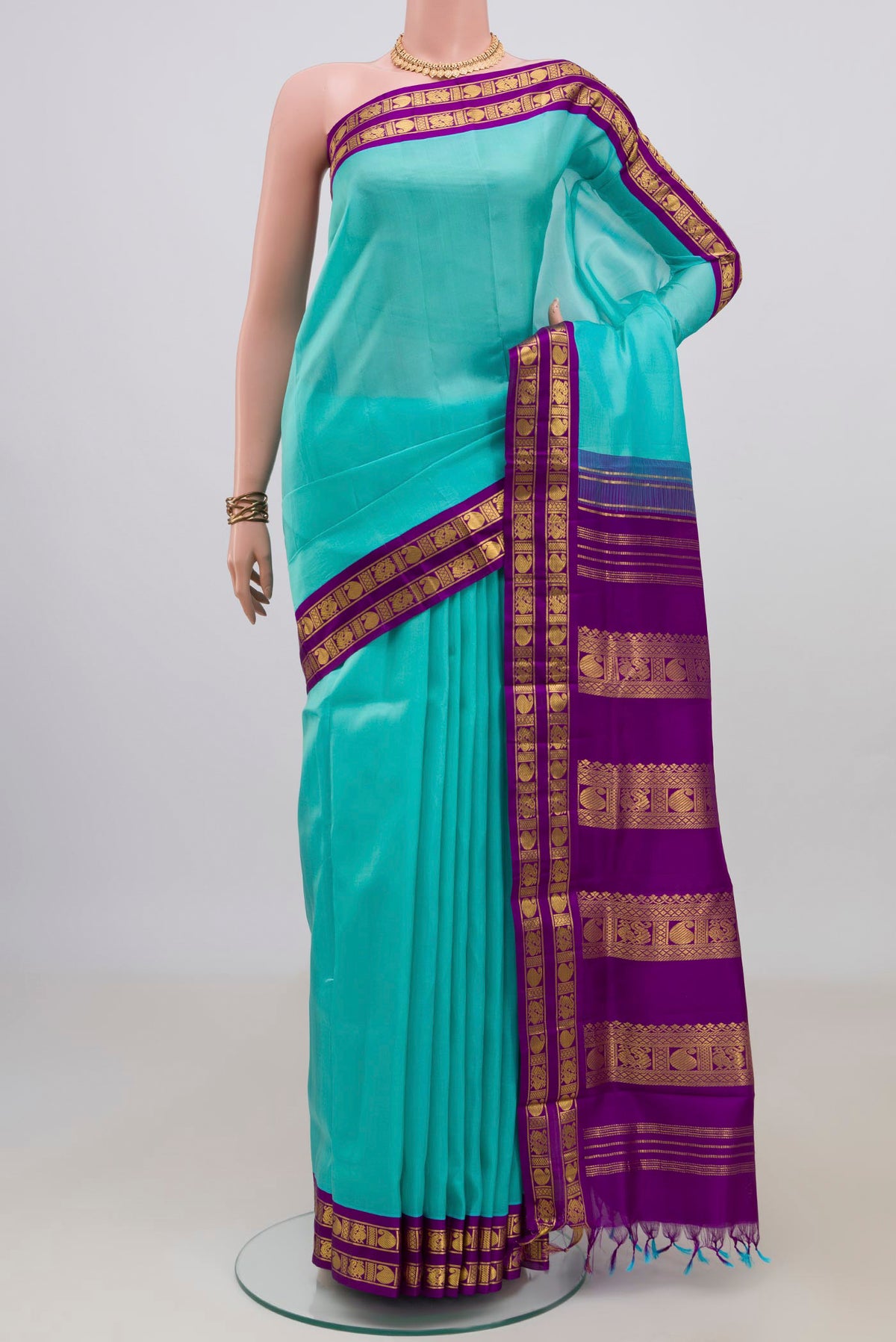 Pure Silk Turquoise Kanjivaram Nine Yards Saree with Plain Body and Zari Border.  displayed on a mannequin