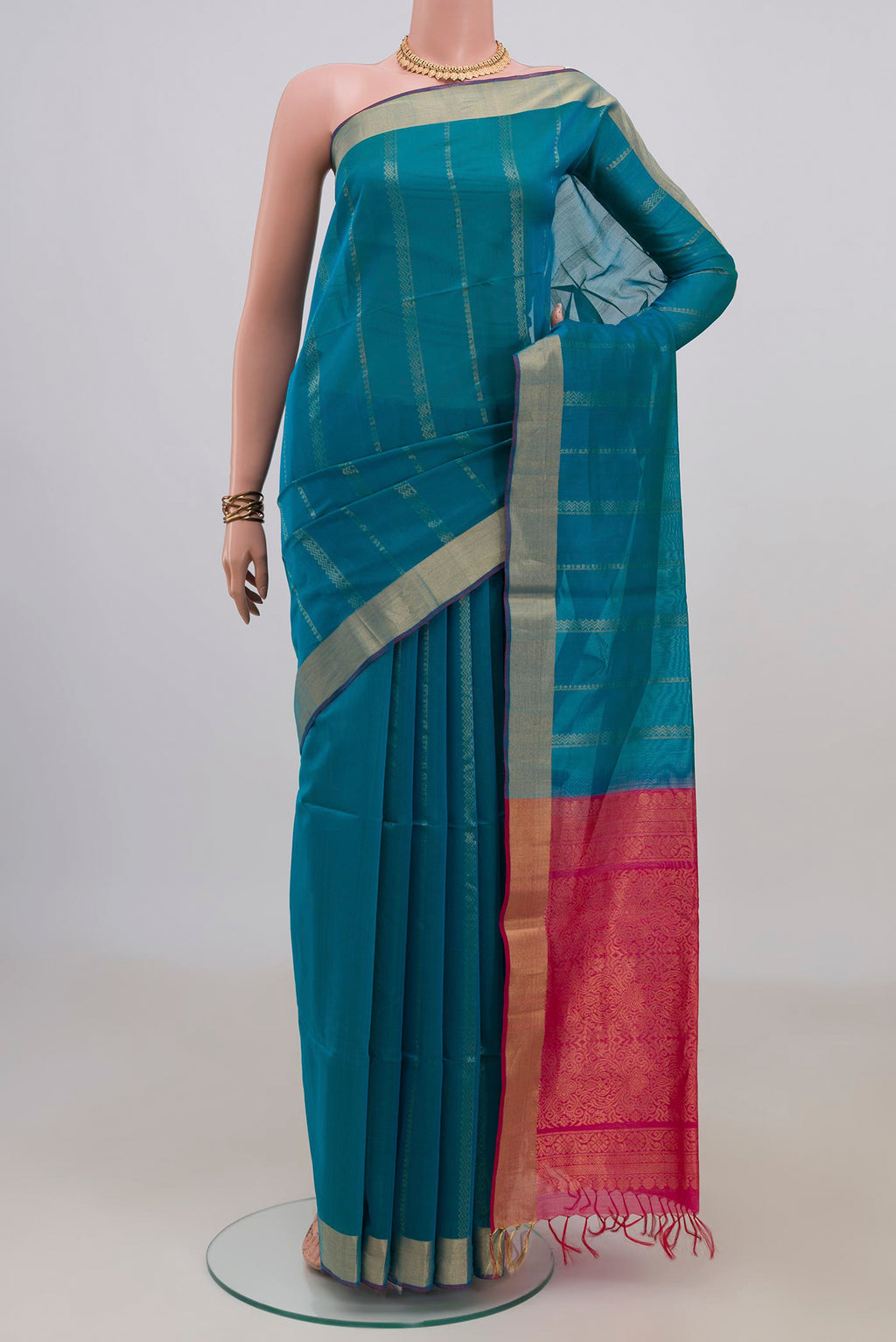 Blue Silk Cotton Saree with Stripes on the body and Zari Border.  displayed on a mannequin