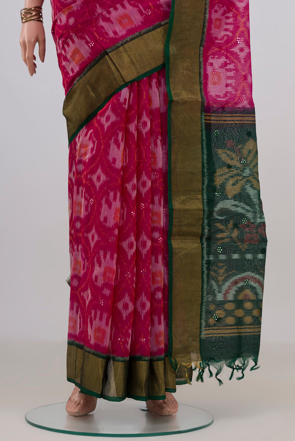 Pleats and pallu of Pink Silk Cotton Saree with Ikat Print on the body and Zari Border. 