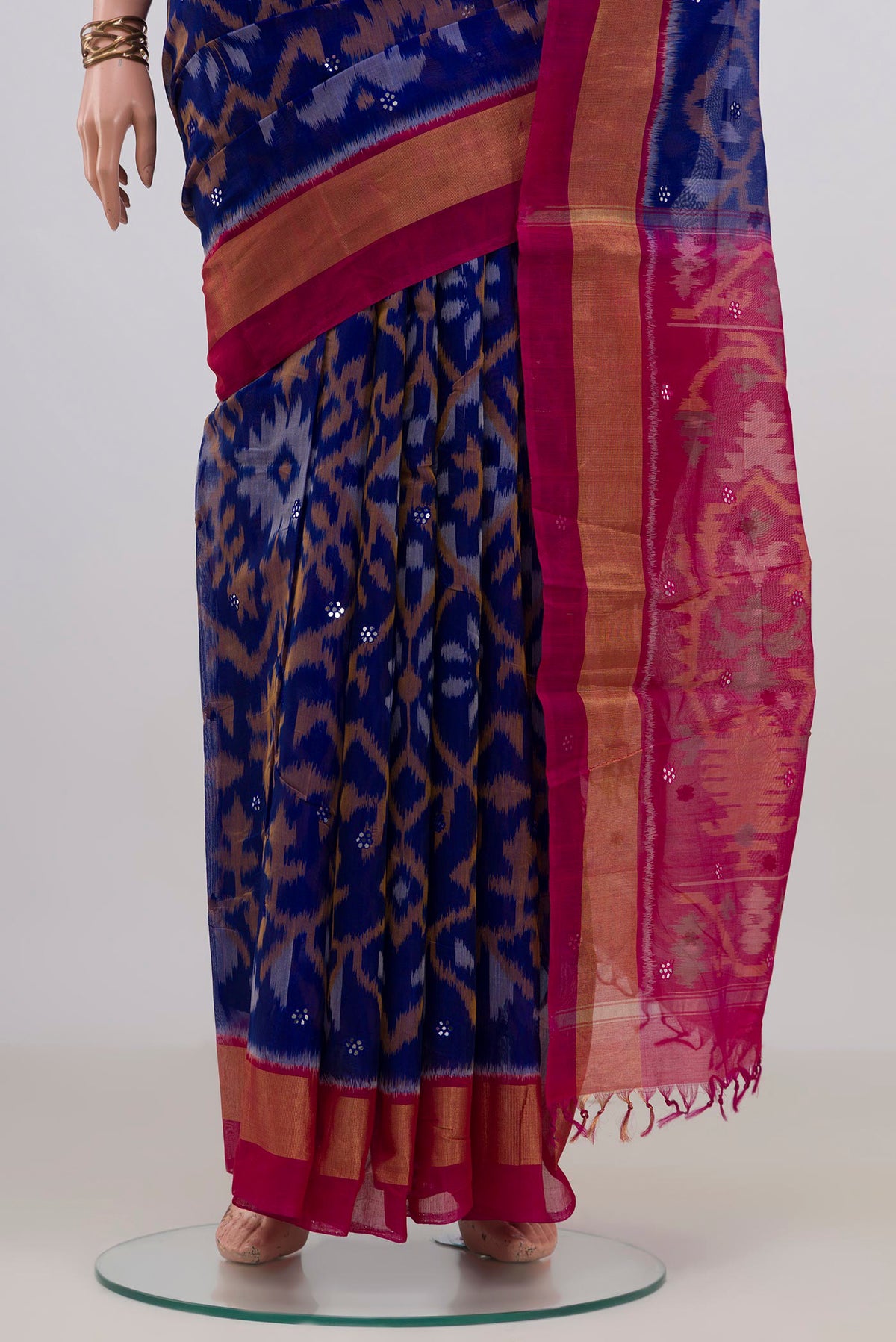 Pleats and pallu of Blue Silk Cotton Saree with Ikat Print on the body and Zari Border. 