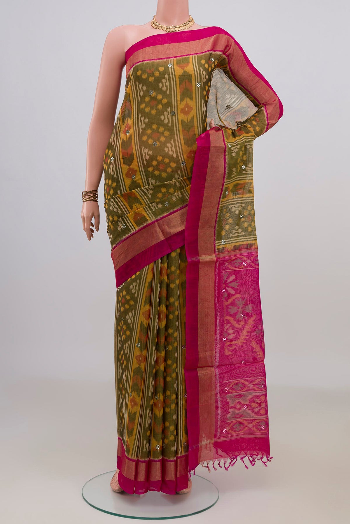 Green Silk Cotton Saree with Ikat Print on the body and Zari Border.  displayed on a mannequin