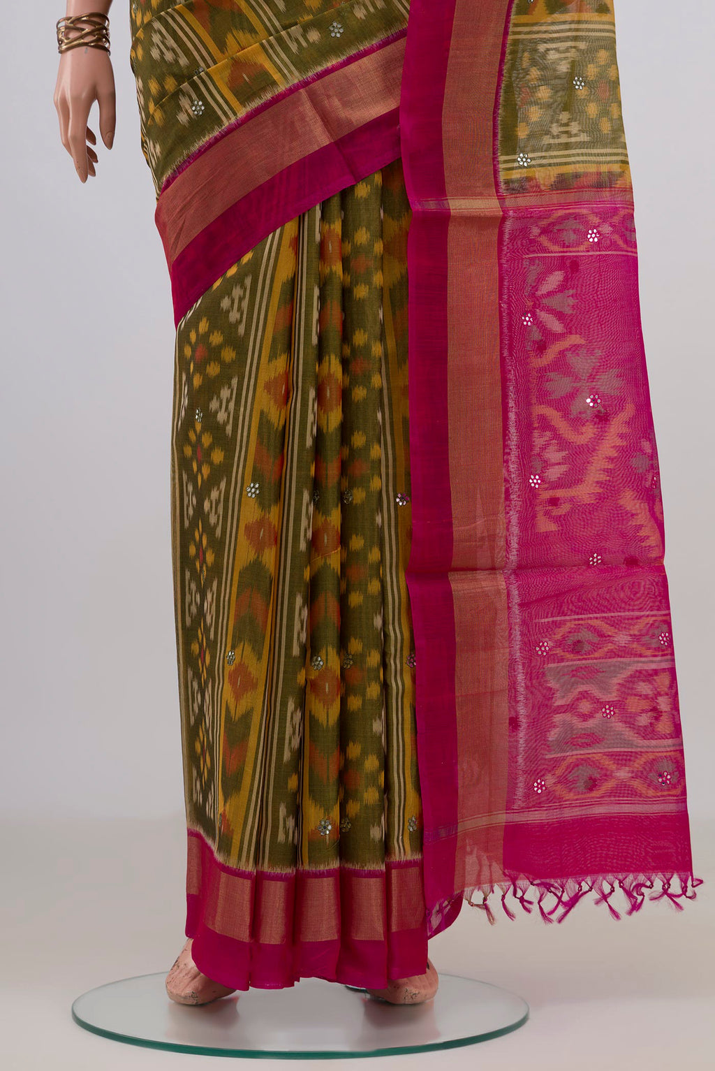Pleats and pallu of Green Silk Cotton Saree with Ikat Print on the body and Zari Border. 