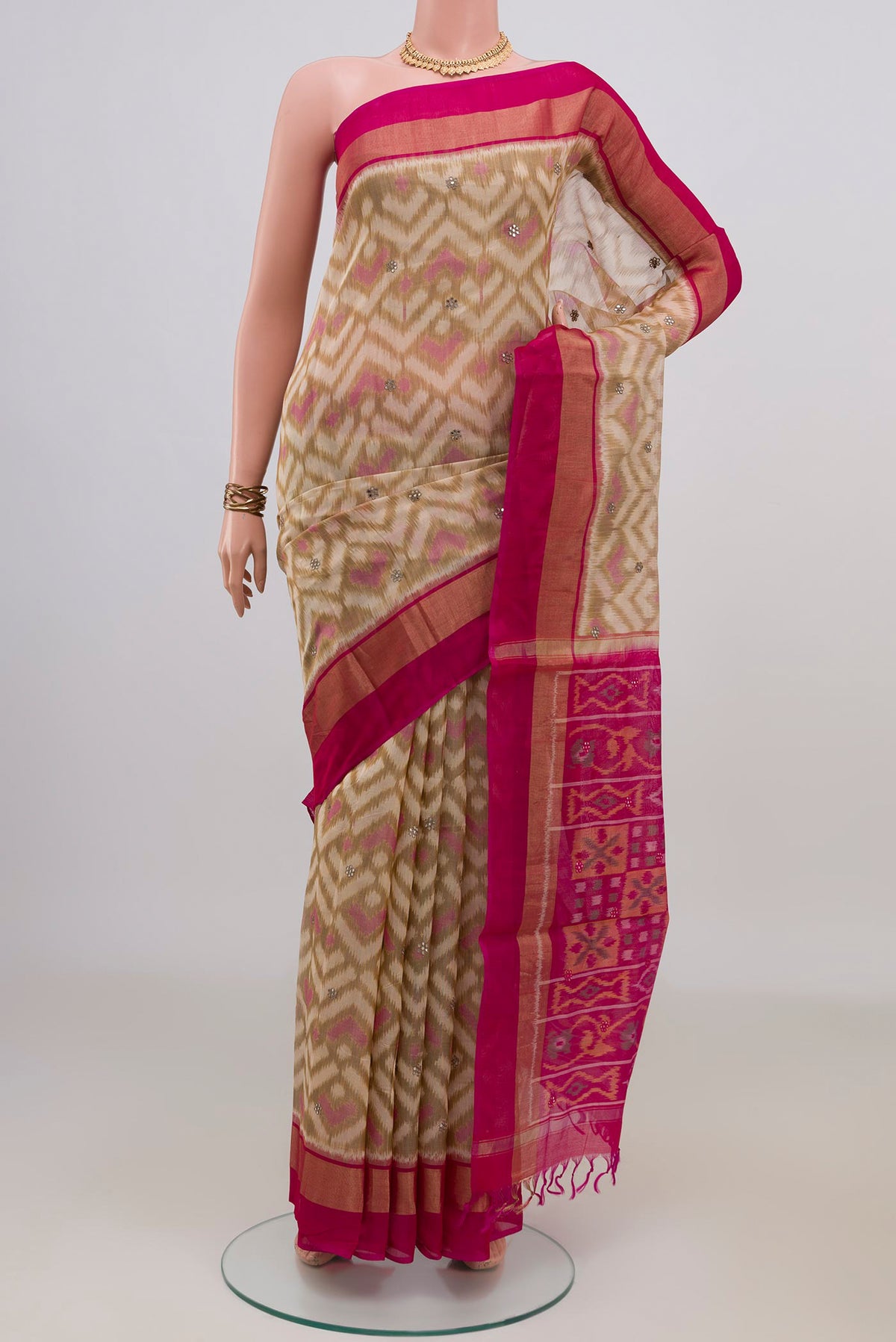 Cream Silk Cotton Saree with Ikat Print on the body and Zari Border.  displayed on a mannequin