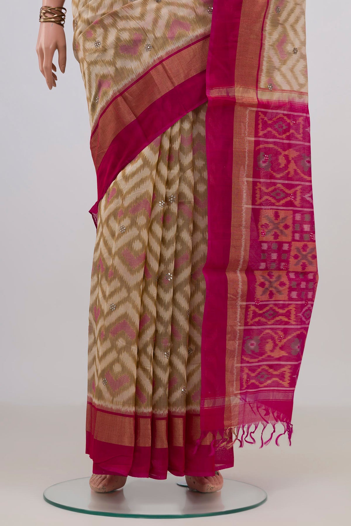 Pleats and pallu of Cream Silk Cotton Saree with Ikat Print on the body and Zari Border. 