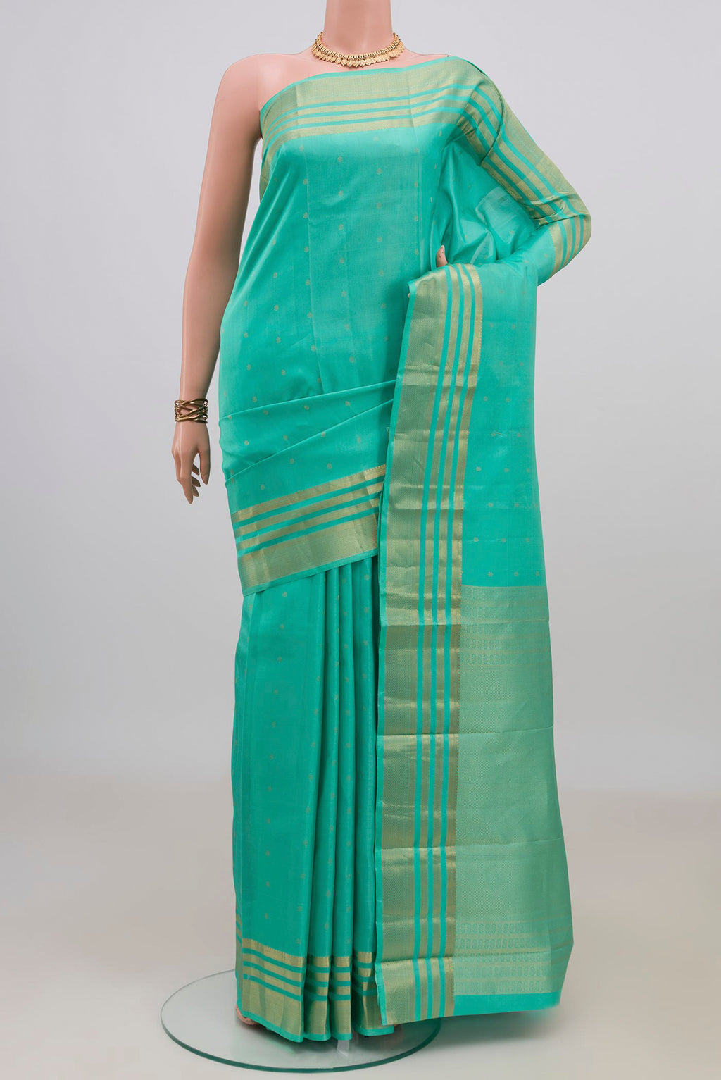 Pure Silk Turquoise Kanchipuram Saree with Zari Butta on the body and Zari Border.  displayed on a mannequin