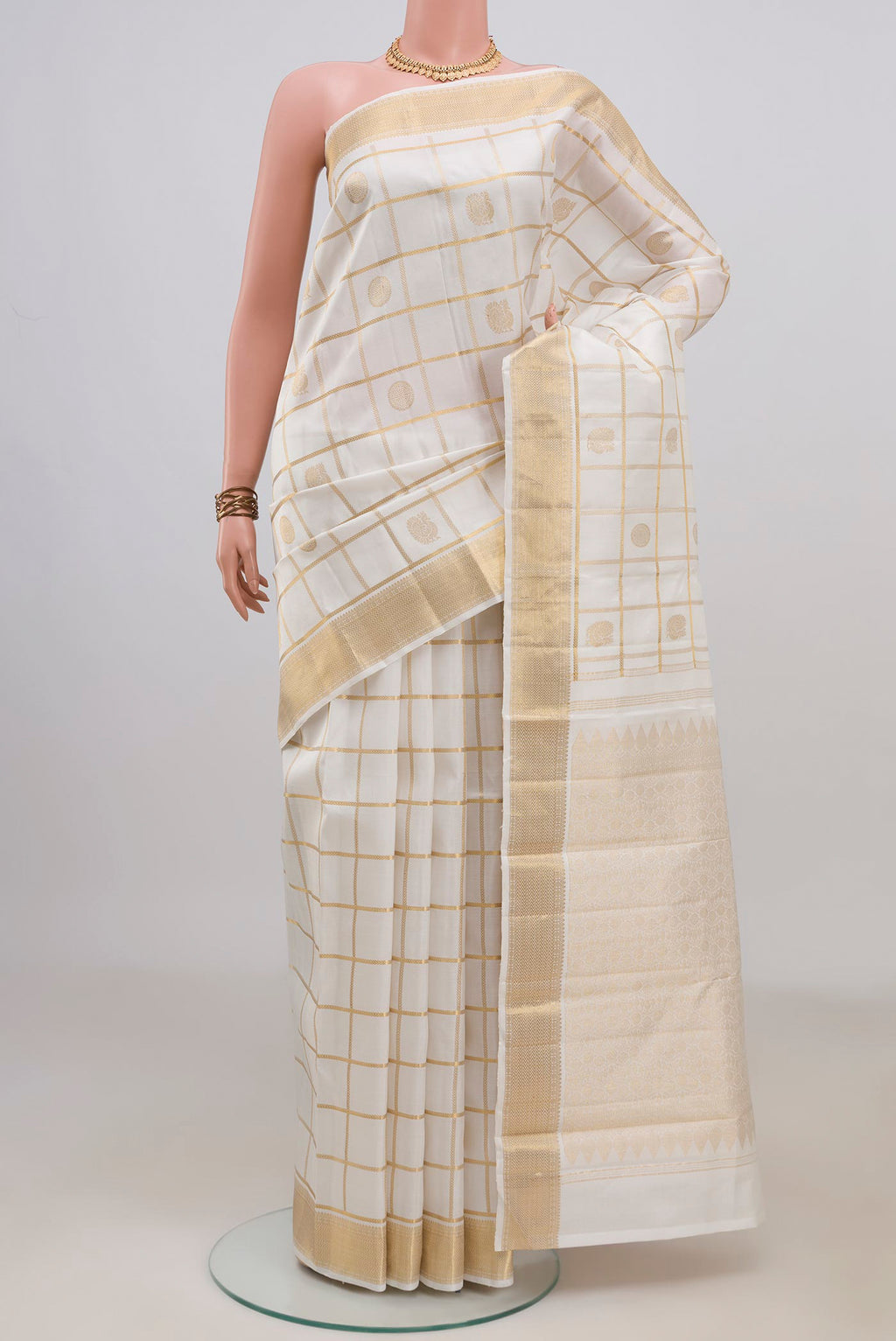 Pure Silk White Kanchipuram Saree with Checked design on the body and Zari Border.  displayed on a mannequin