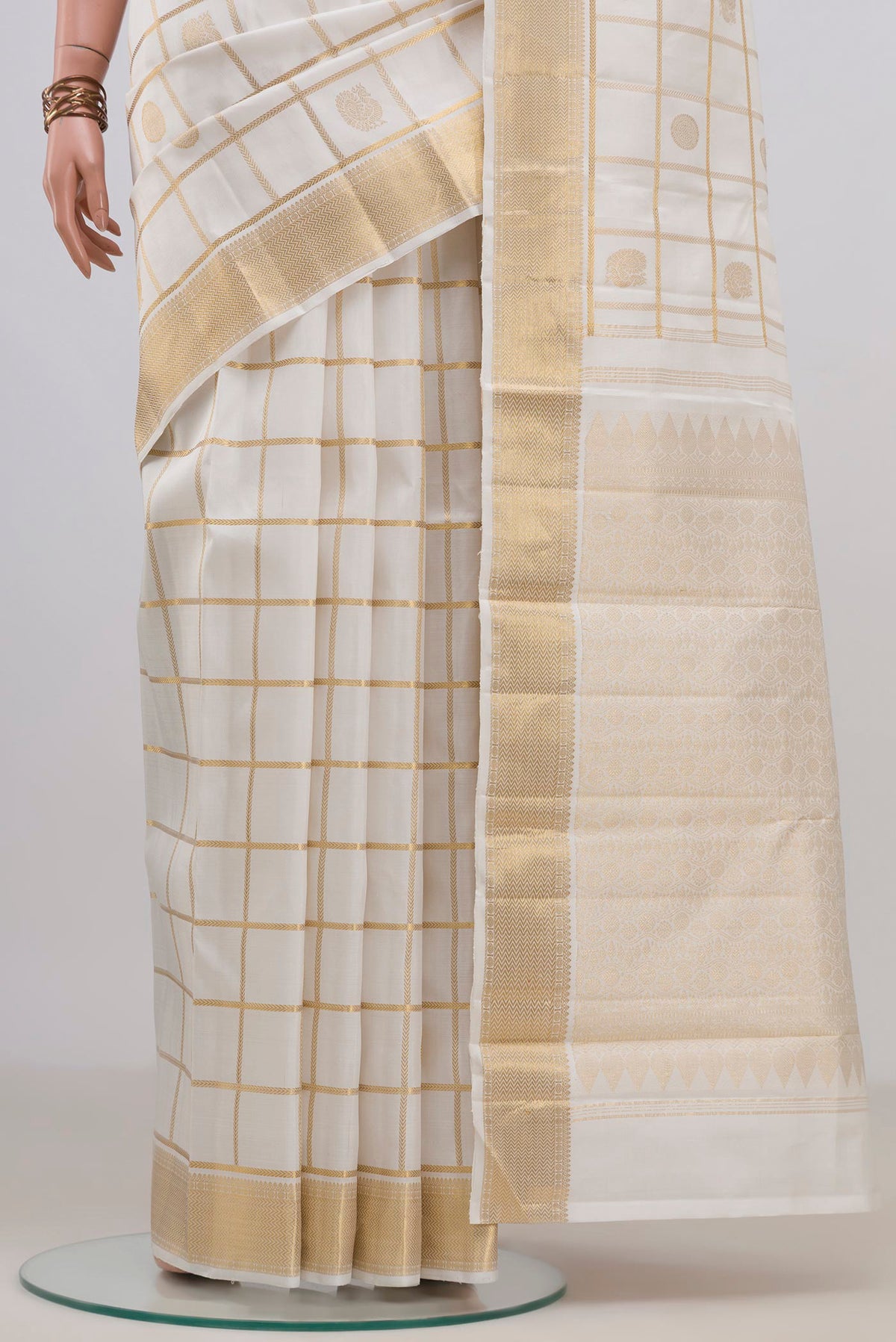 Pleats and pallu of Pure Silk White Kanchipuram Saree with Checked design on the body and Zari Border. 