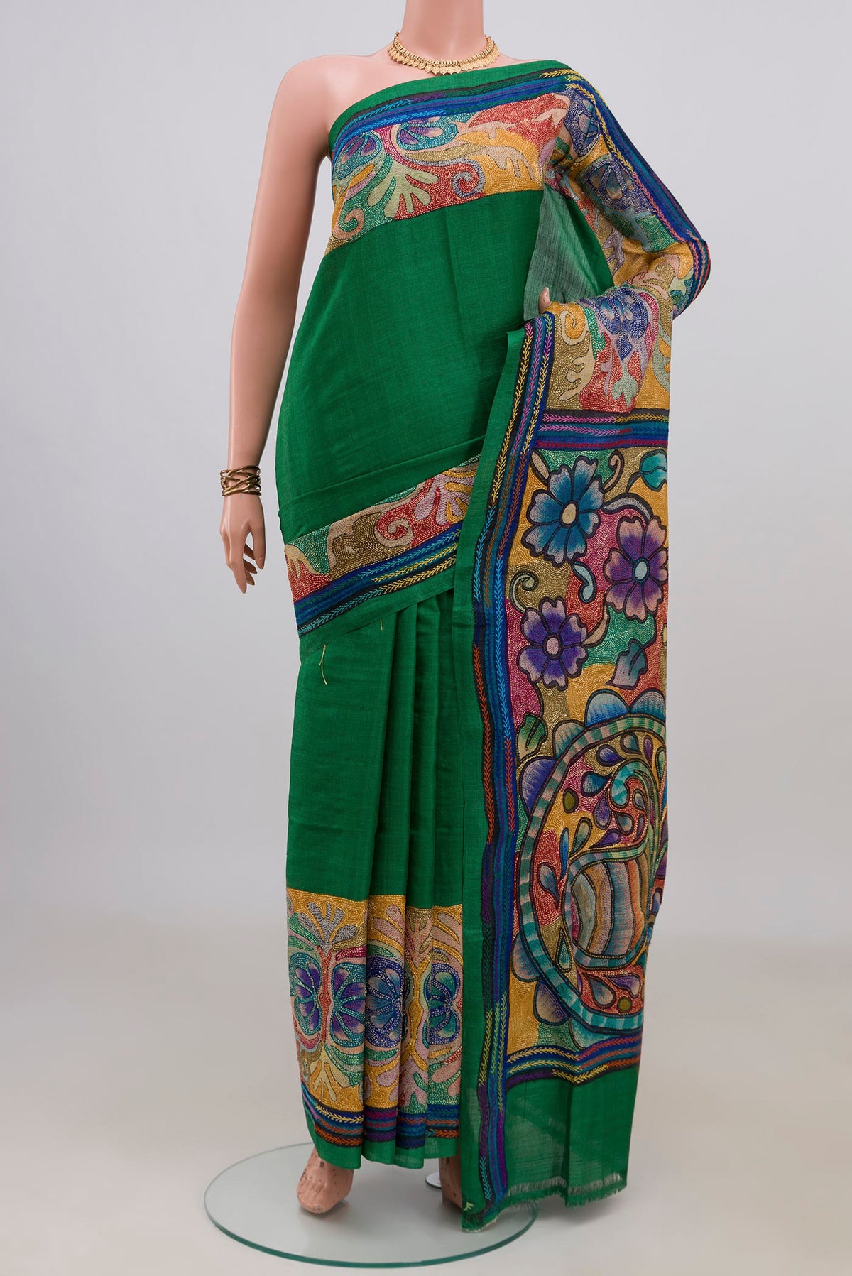 Green Tussar Saree with Plain Body and Embroidery Border.  displayed on a mannequin