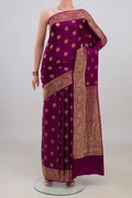 Magenta Banarasi Saree with Zari Butta on the body and Fancy Border.  displayed on a mannequin