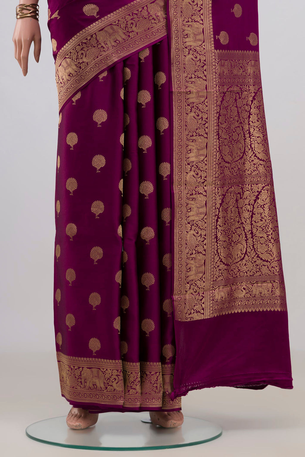 Pleats and pallu of Magenta Banarasi Saree with Zari Butta on the body and Fancy Border. 