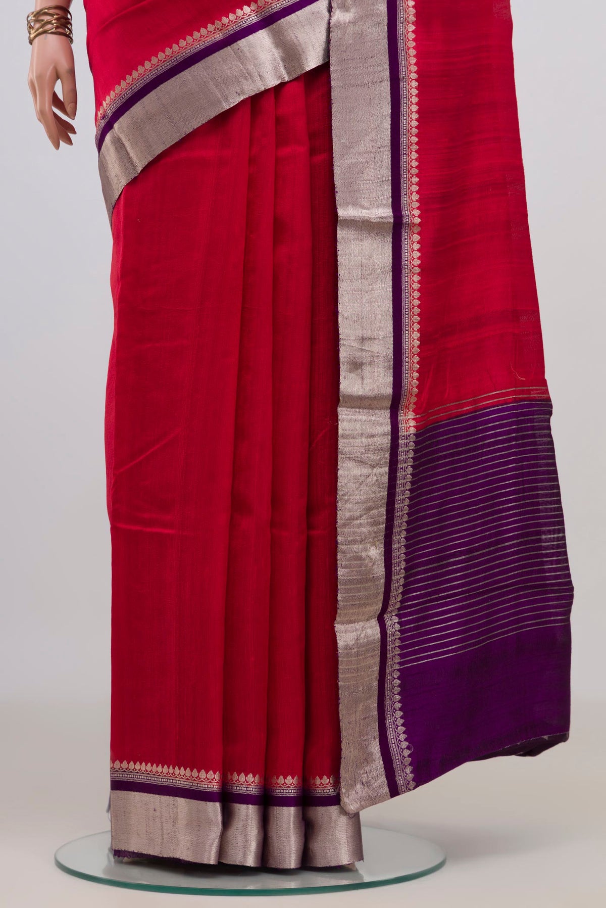 Pleats and pallu of Pure Silk Red Raw Saree with Plain Body and Zari Border. 