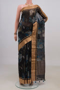 Black Tussar Saree with Printed design on the body and Zari Border.  displayed on a mannequin