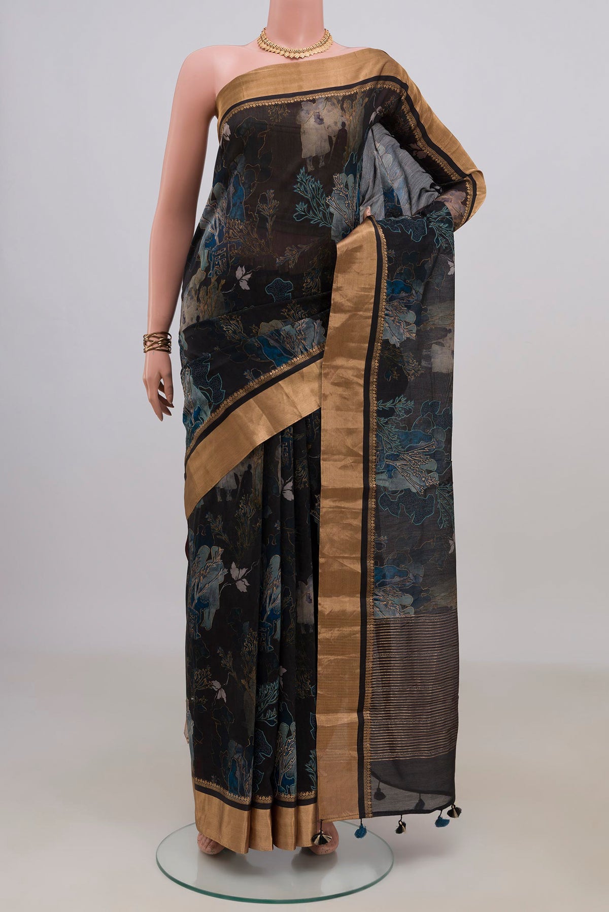 Black Tussar Saree with Printed design on the body and Zari Border.  displayed on a mannequin