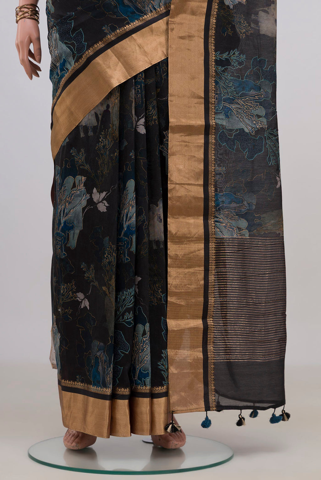 Pleats and pallu of Black Tussar Saree with Printed design on the body and Zari Border. 