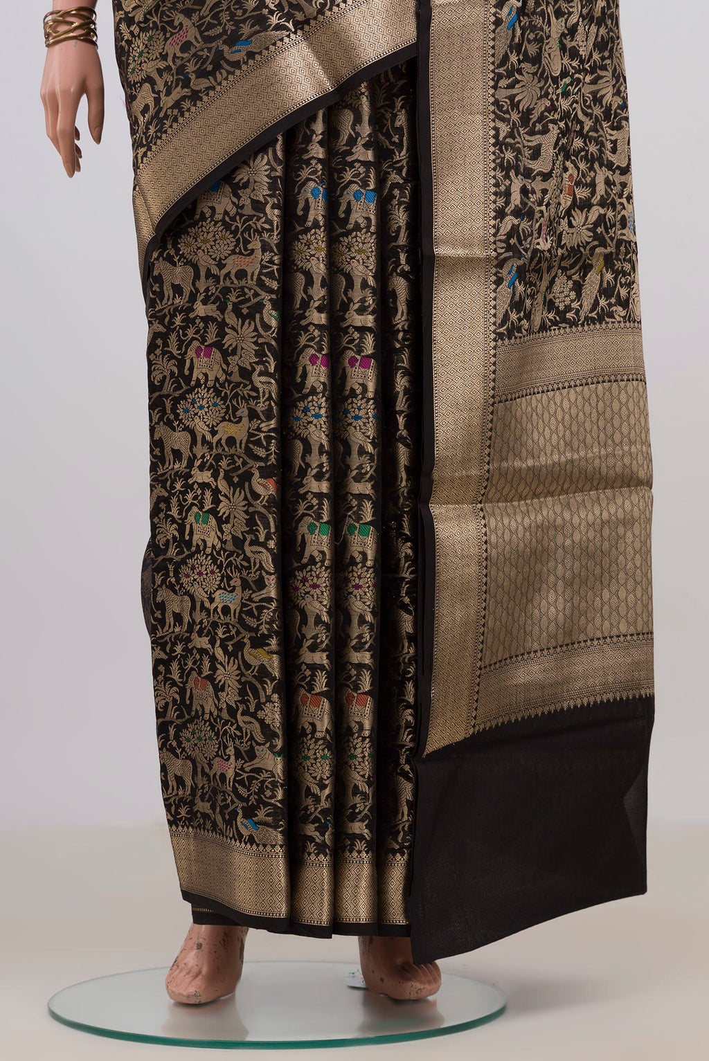 Pleats and pallu of Pure Silk Black Raw Saree with Zari Brocade on the body and Zari Border. 