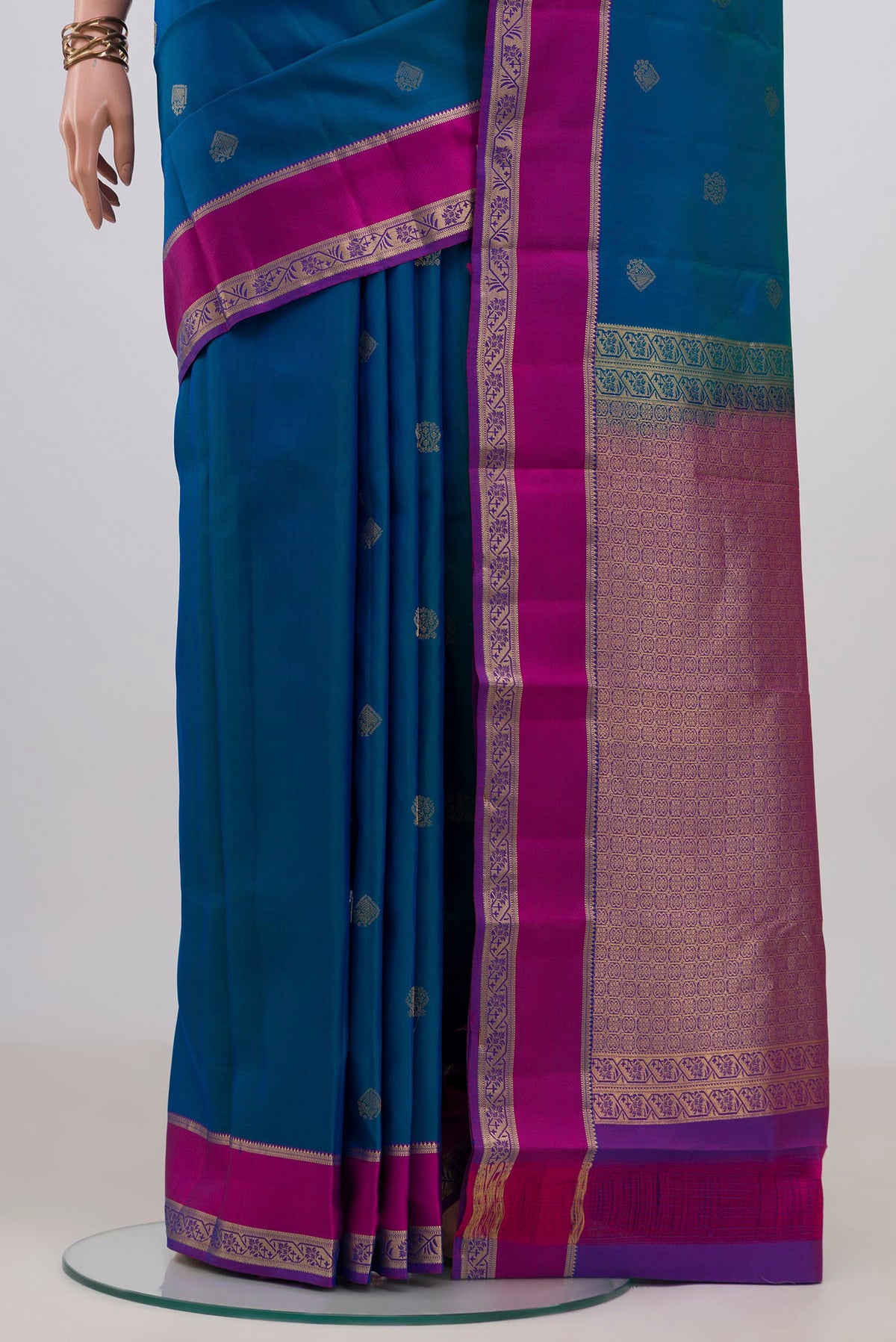 Pleats and pallu of Pure Silk Peacock Blue Kanchipuram Saree with Zari Butta on the body and Zari Border. 
