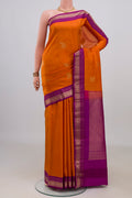 Pure Silk Orange Kanchipuram Saree with Zari Butta on the body and Zari Border.  displayed on a mannequin