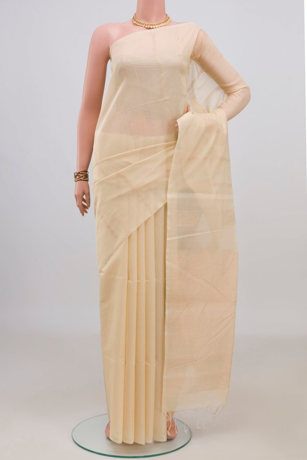 Cream Silk Cotton Saree with Zari Butta on the body and Without Border.  displayed on a mannequin