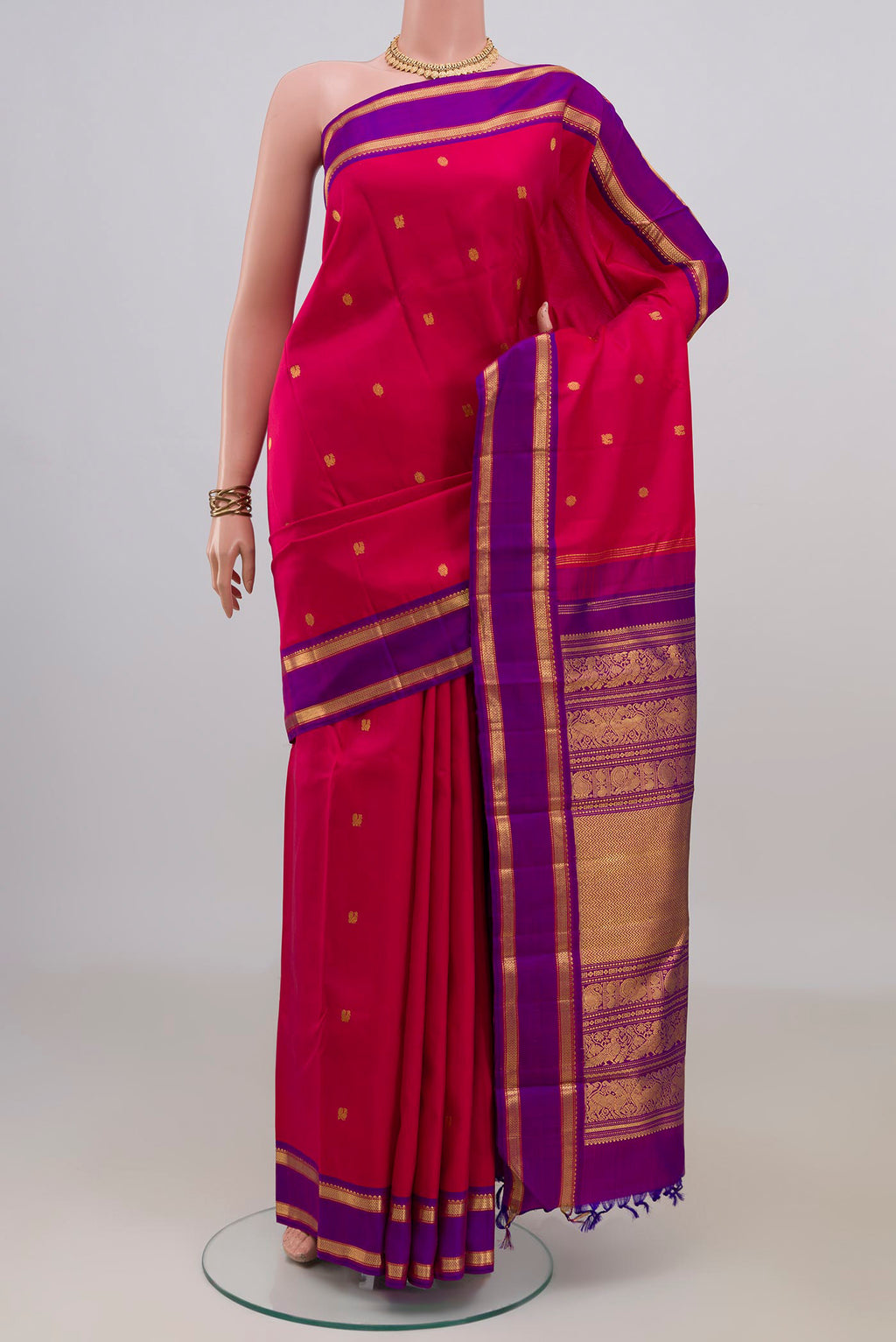 Pure Silk Pink Kanjivaram Saree with Zari Butta on the body and Zari Border.  displayed on a mannequin