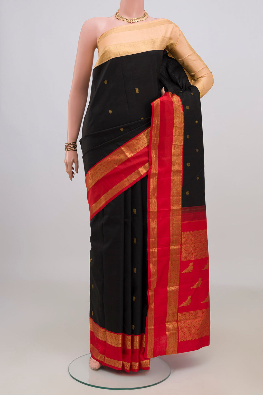 Pure Silk Black Kanjivaram Saree with Zari Butta on the body and Ganga Jamuna Border.  displayed on a mannequin