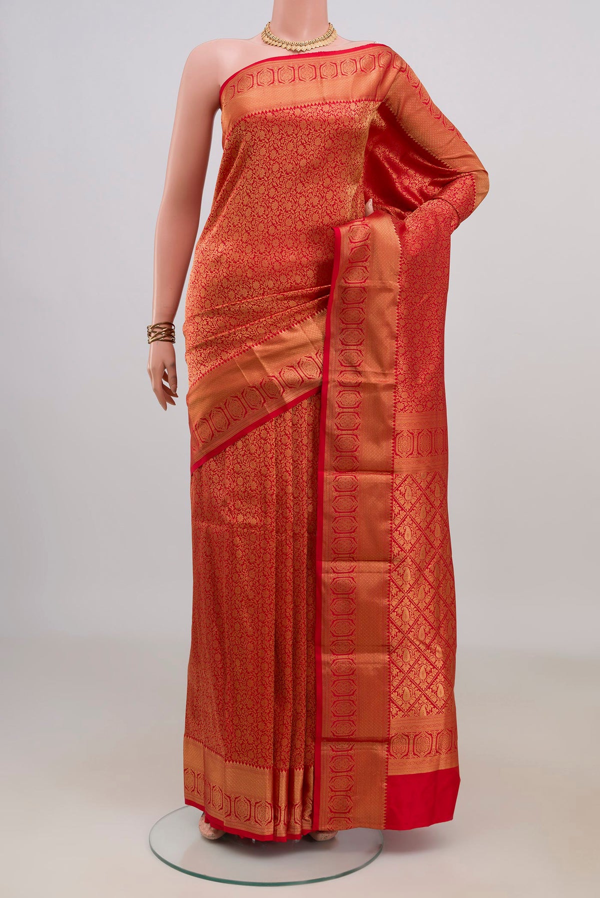 Pure Silk Red Kanjivaram Saree with Zari Brocade on the body and Zari Border.  displayed on a mannequin