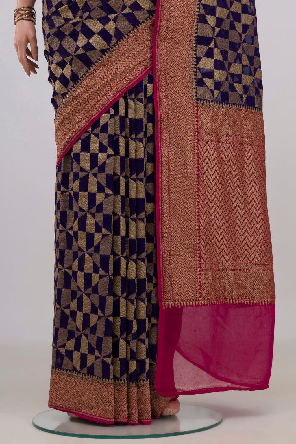Pleats and pallu of Navy Blue Banarasi Georgette Saree with Fancy on the body and Zari Border. 