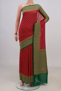 Red Banarasi Georgette Saree with Zari Butta on the body and Fancy Border.  displayed on a mannequin