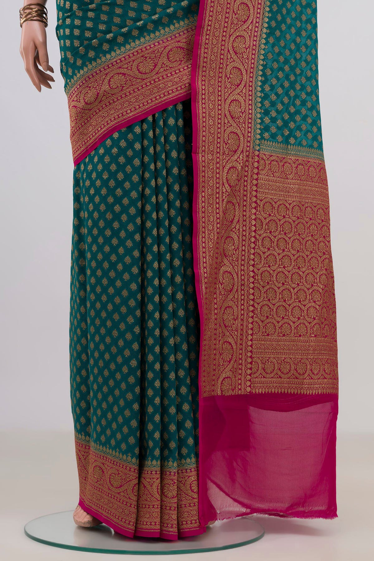 Pleats and pallu of Teal Banarasi Georgette Saree with Zari Butta on the body and Fancy Border. 