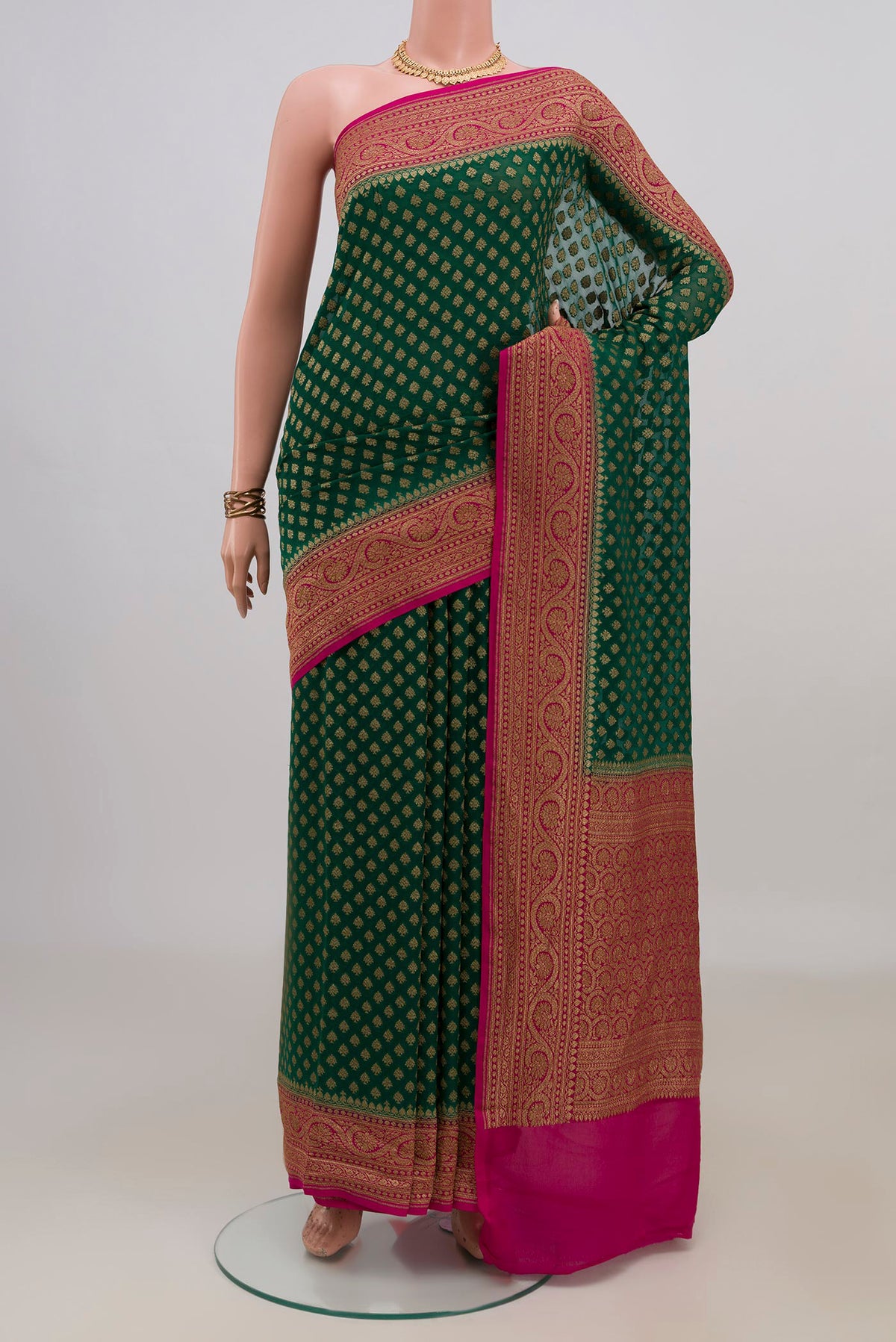 Green Banarasi Georgette Saree with Zari Butta on the body and Zari Border.  displayed on a mannequin