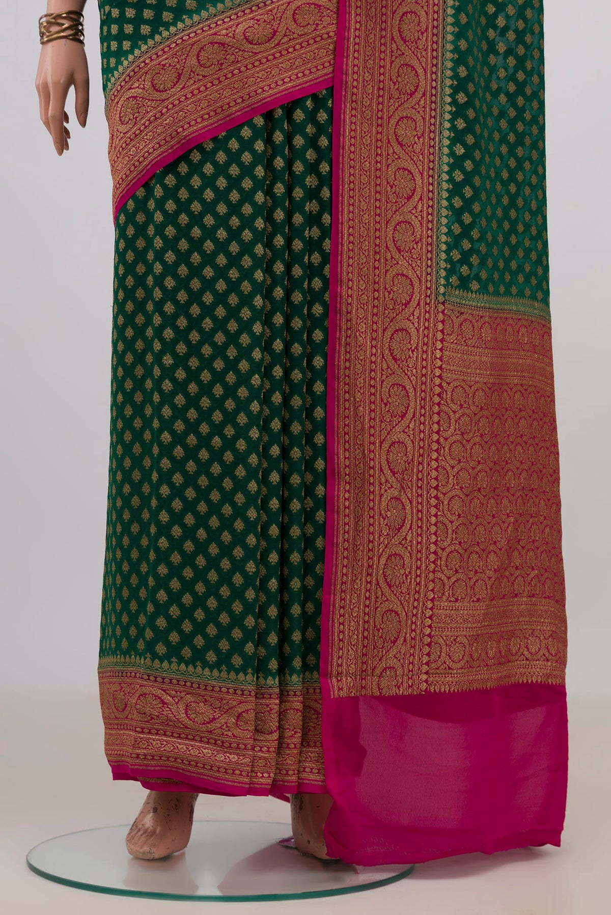 Pleats and pallu of Green Banarasi Georgette Saree with Zari Butta on the body and Zari Border. 